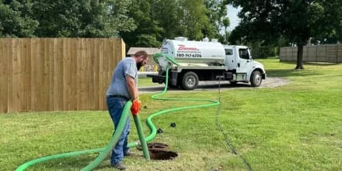 Brower Inc. portable restroom positioned at an active Oklahoma construction site with workers and equipment visible
