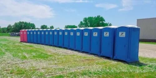 Row of Brower Inc. portable restrooms lined up and ready for outdoor event in Oklahoma