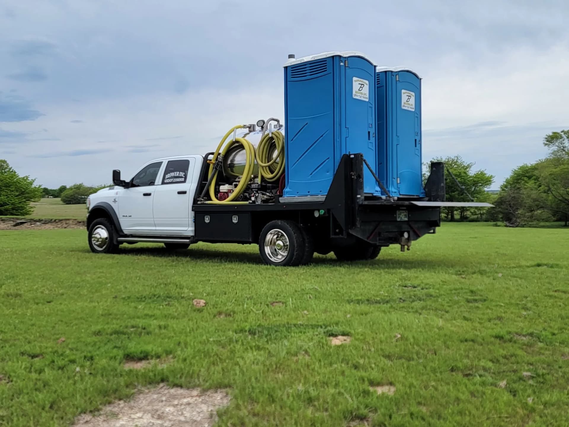 Brower Inc. service truck delivering a porta potty to a rural Oklahoma property in Kay County